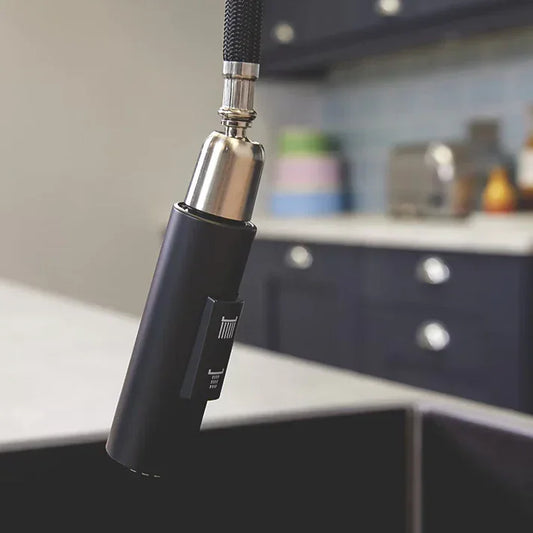 Matt black pull-out kitchen tap spray nozzle with modern design in luxury kitchen setting