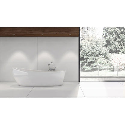 Modern bathroom with large white tiles, freestanding tub, wood accent, and garden view