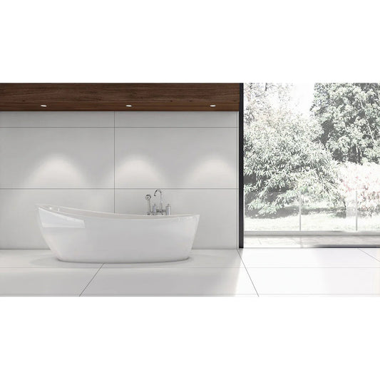Modern bathroom with large white tiles, freestanding tub, wood accent, and garden view